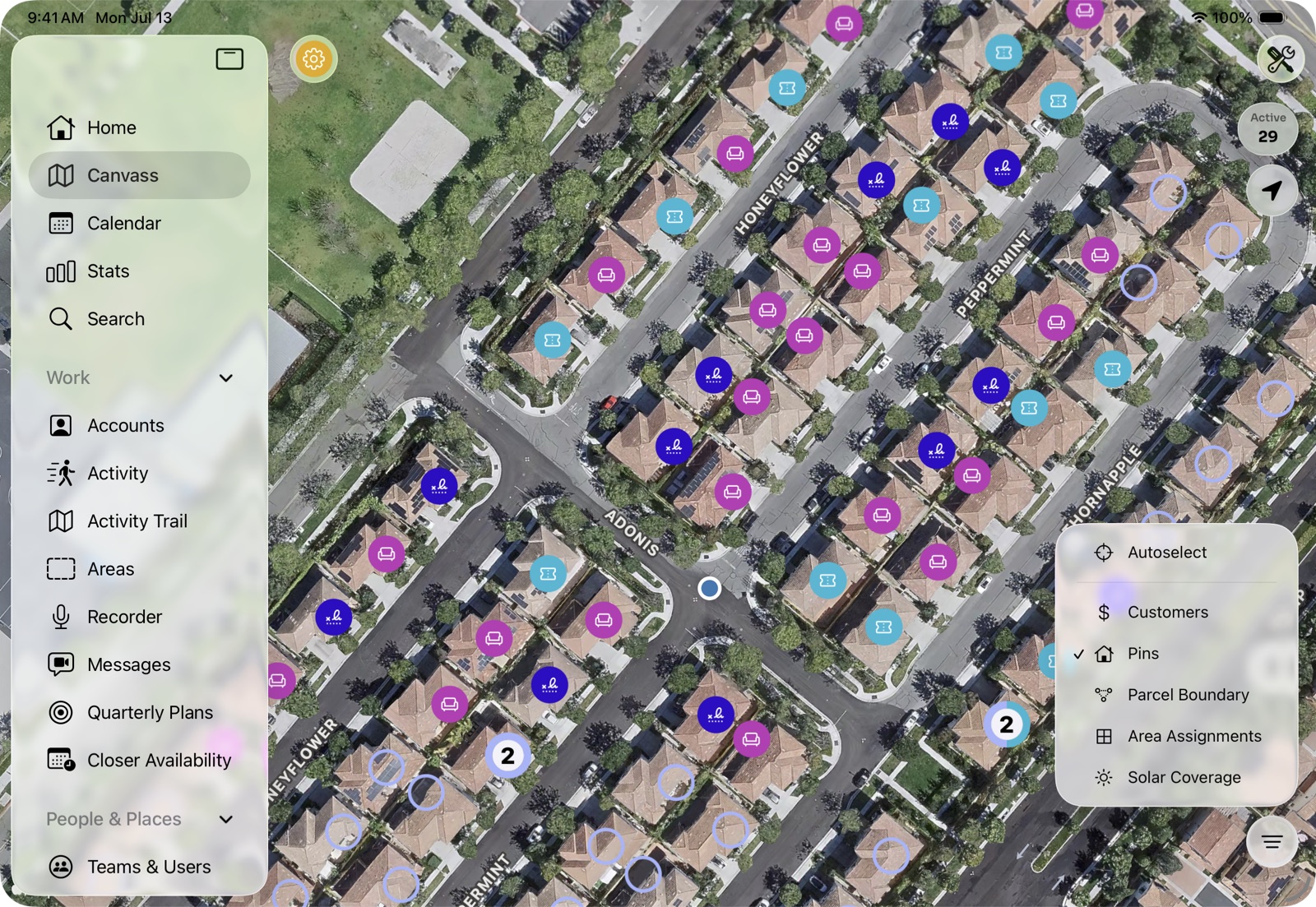 The Canvass map in satellite view, streets dotted with color-coded pins, with the map-layers menu open.